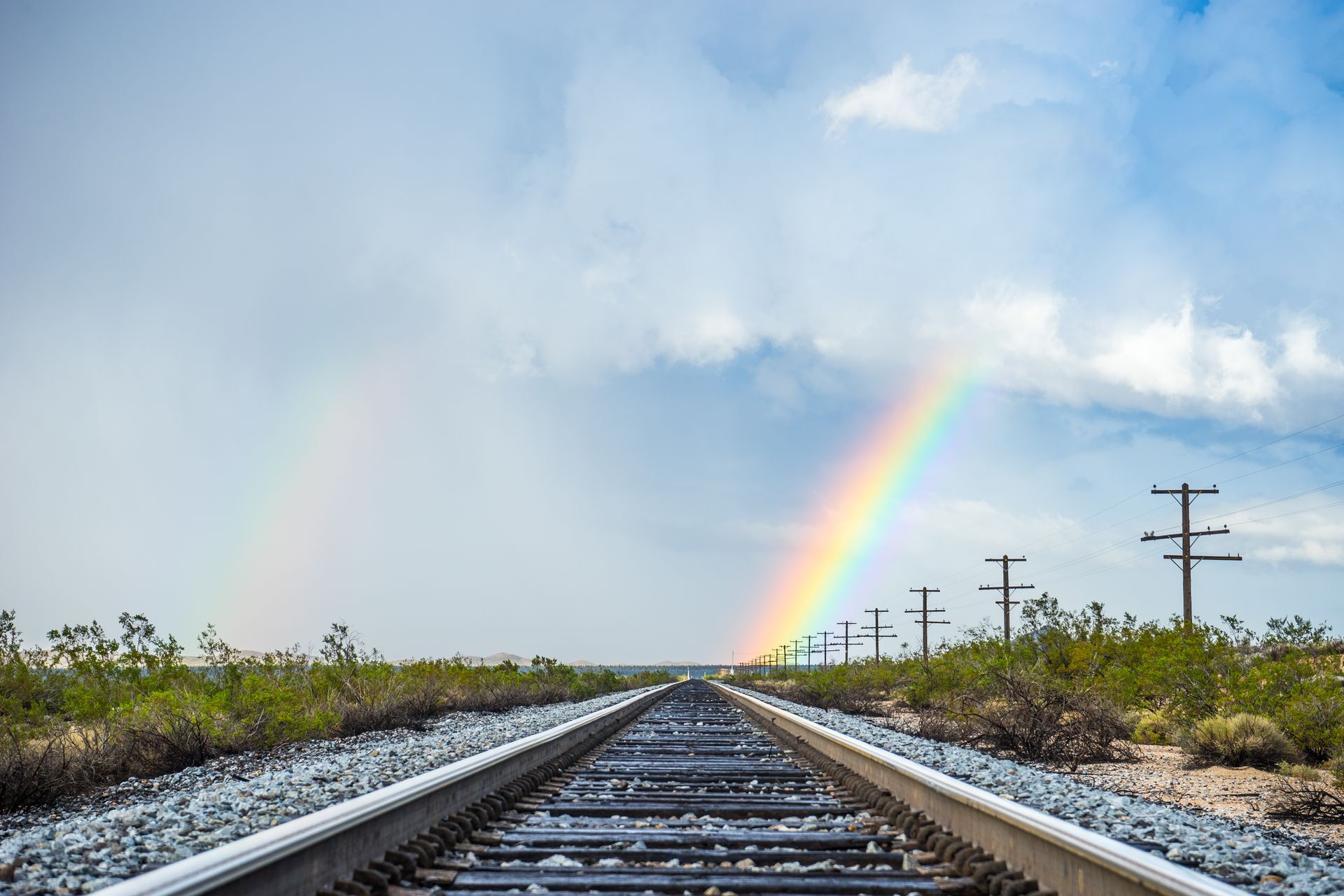 Rainbow over a railway.
